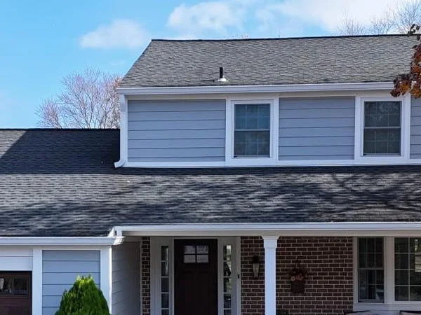 Two-story home with new blue siding installed